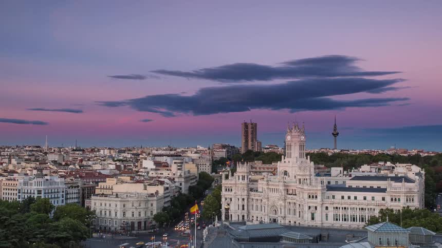Time lapse of a busy city street as the sun sets over Cibeles palace