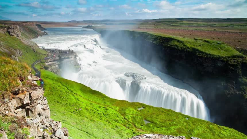 The waterfall is giving off mist all over