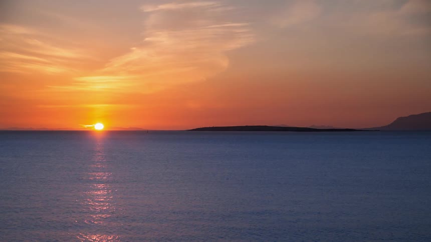 Time lapse of the sun setting over the ocean