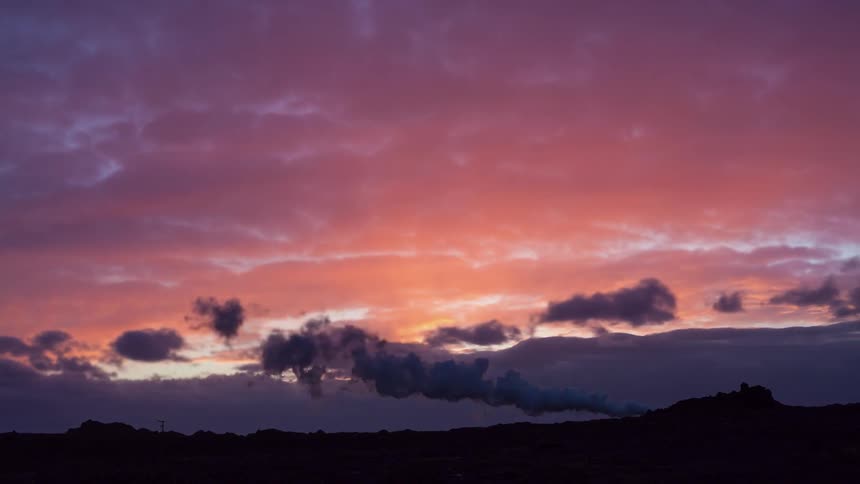Time lapse of clouds blowing by during sunset