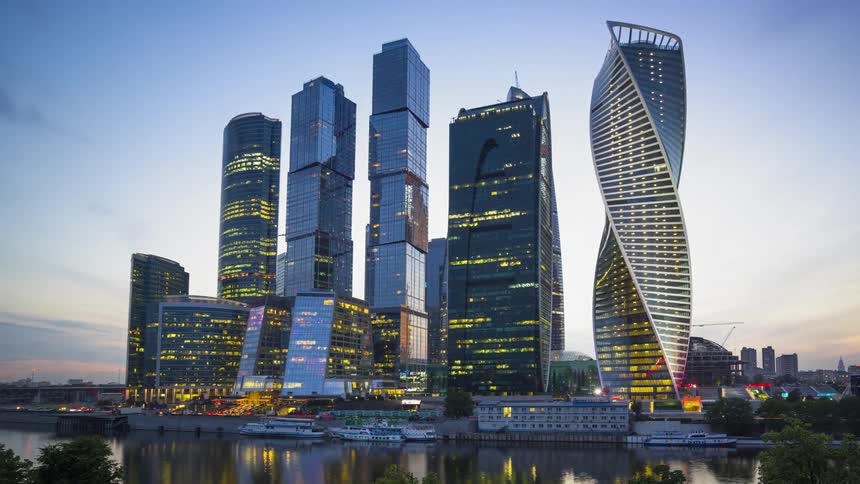 City skyscrapers glow at sunset