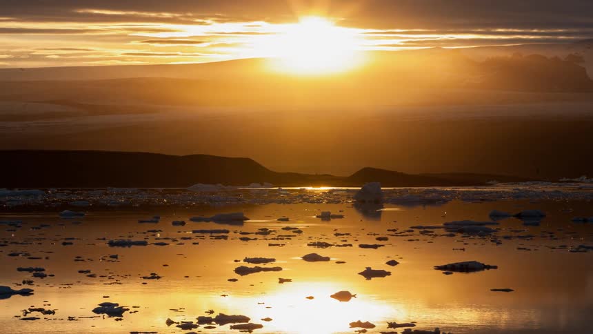 Icebergs shift as as the sun rises