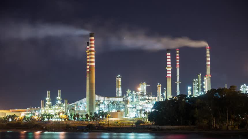 Smoke billows out of a factory