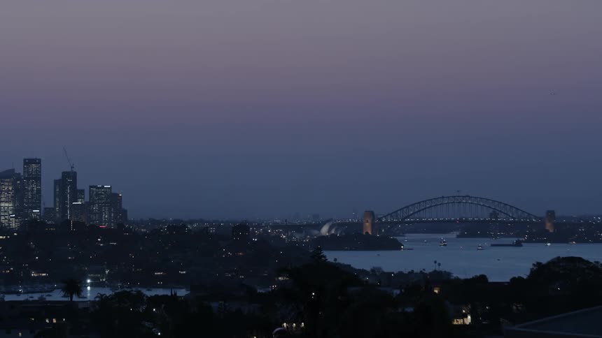 A cityscape is shown at dusk