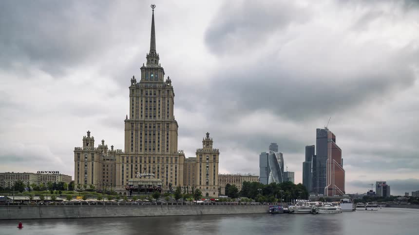 The boats sail past the Lomonosov Institute in Moscow