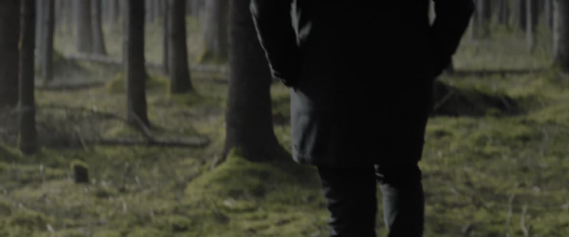 A person is walking in the green grass
