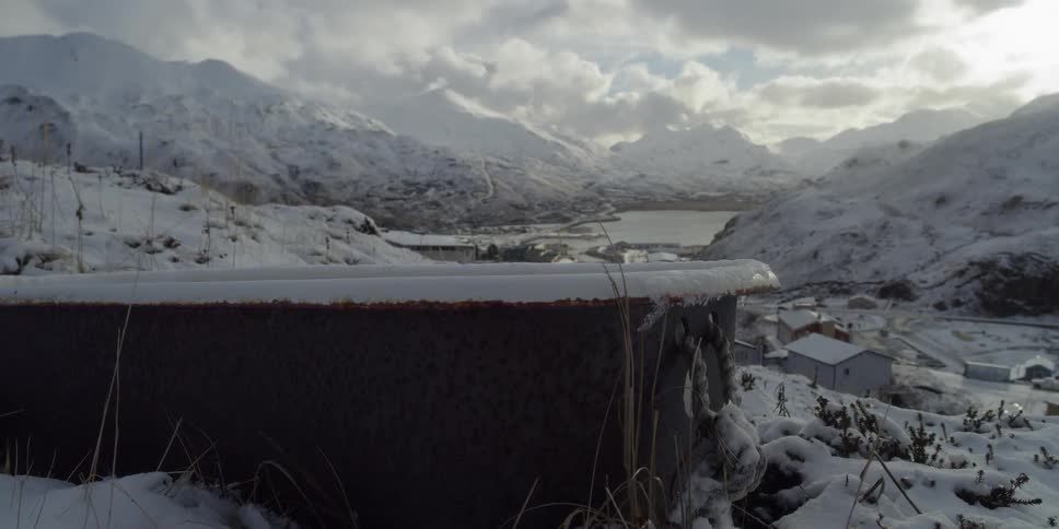 A rusted tub sits on the snow covered ground