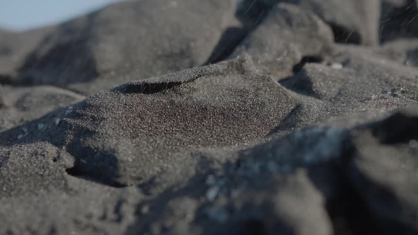 Wind blows through sand pebbles