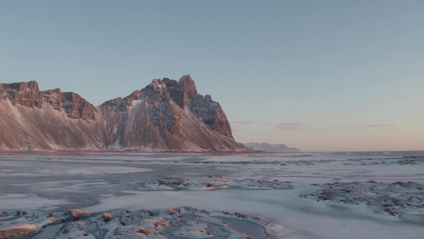 A frozen lake near mountains