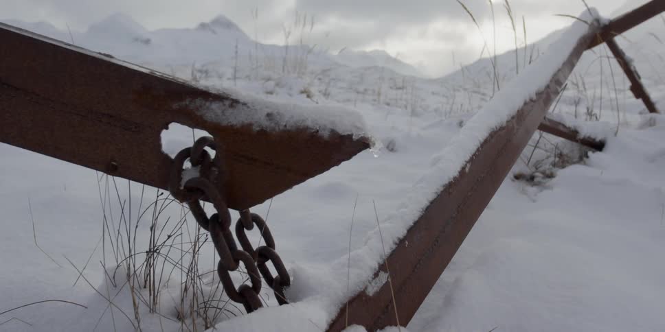 A chained metal fence in the snow