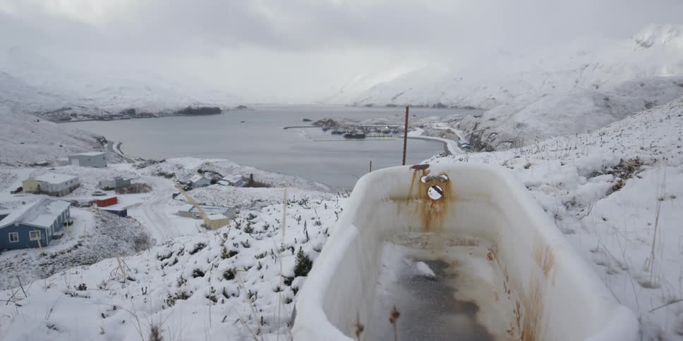 A rusted out tub on a snowy hill