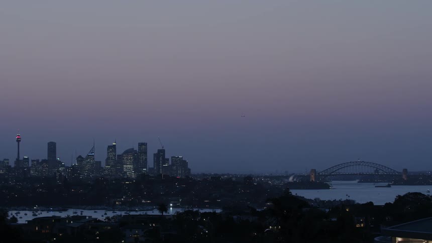 A cityscape is shown at dusk