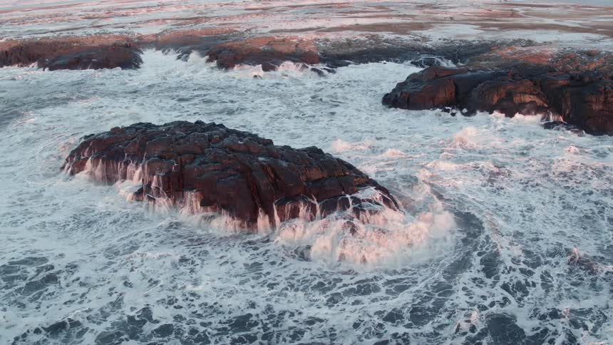 Rough seas are crashing against rocks