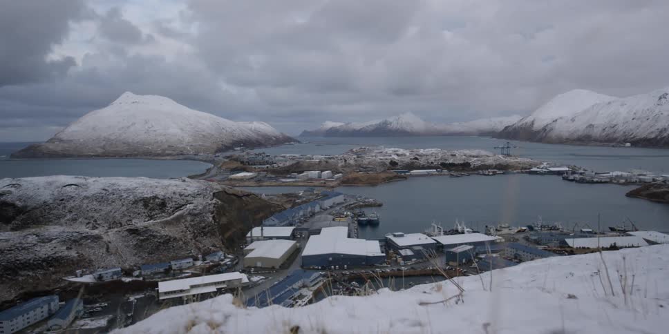 The snow covered hills lead to the shore
