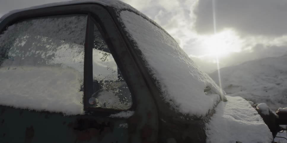 A snow covered window of a truck