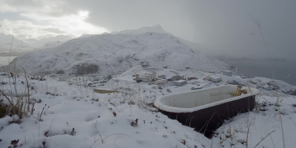 A rusty tub on a snowy hill