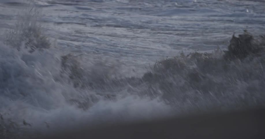 Ocean waves crash into a sandy beach