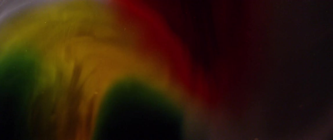 Close up of green, yellow and red swirling colors