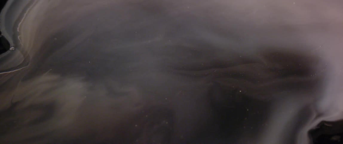 Lights glow through clouds at night