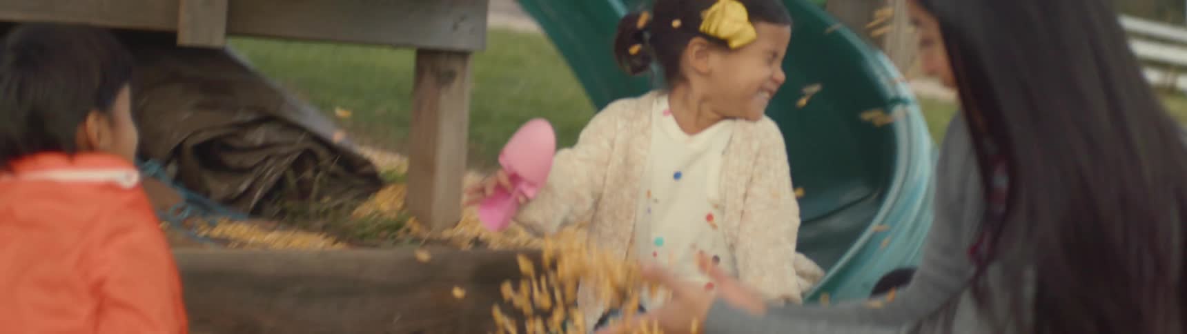 A girl goes down a slide on a playground