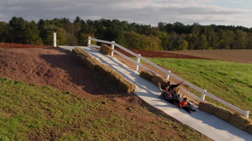A family of four are sliding down a hill together