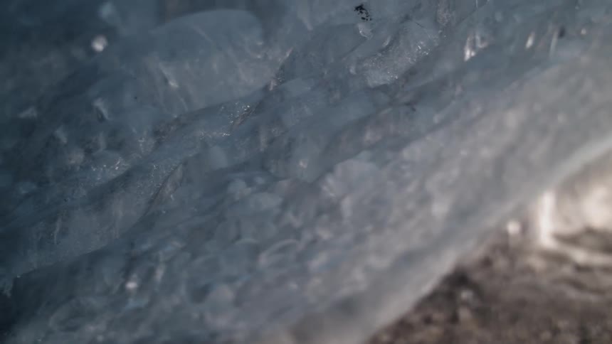 Ice on rock starts to melt and drip
