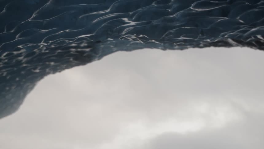 Water drips from a rock on a cloudy day