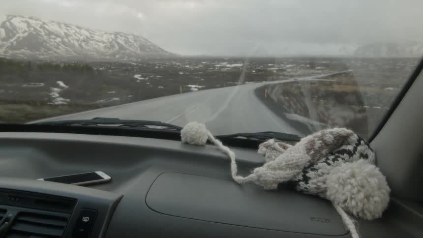 A car is traveling through a flat frozen landscape