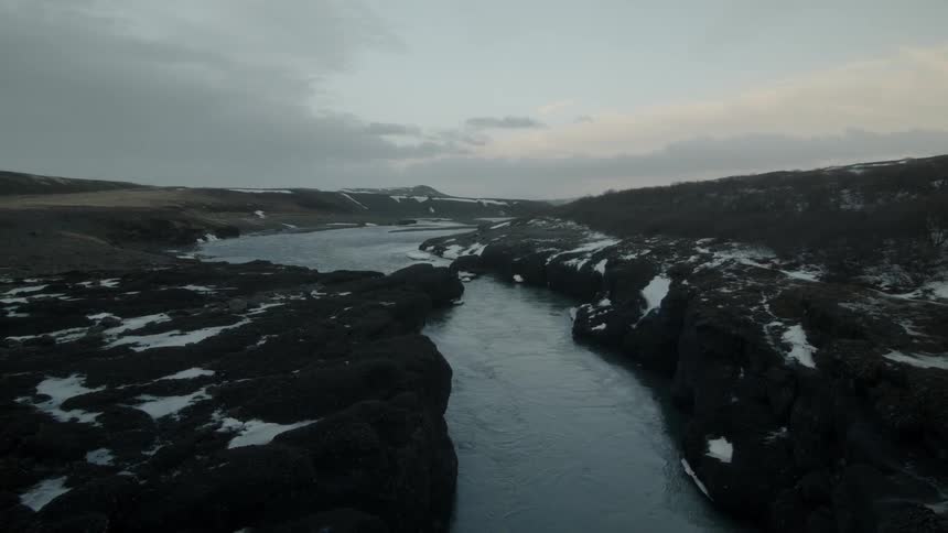 A river flows through a rural area at sunset