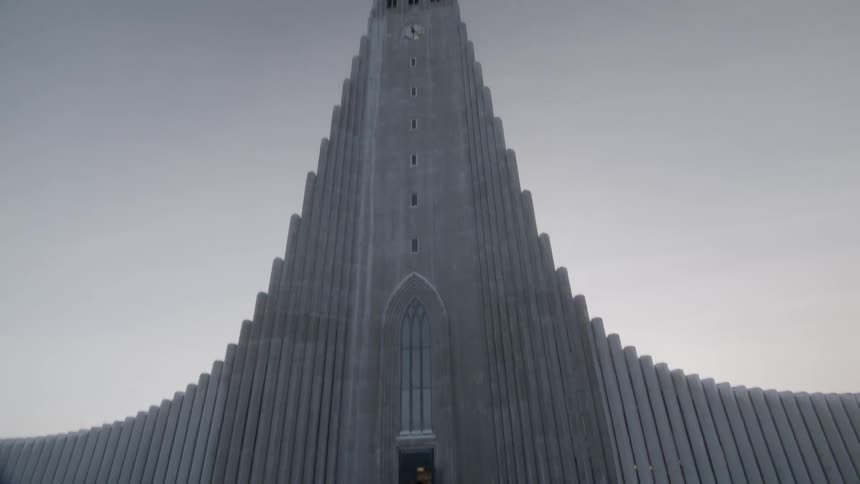 People are standing outside an architecturally interesting building on a winter's day