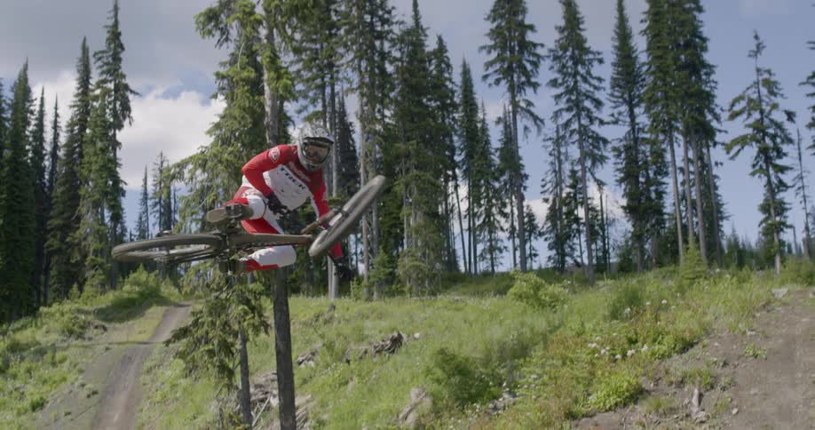 A person jumps up over the hill on the bike