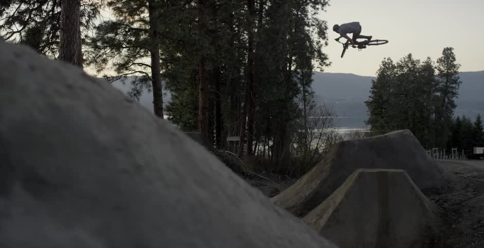Mountain Biker hits jump at sunset