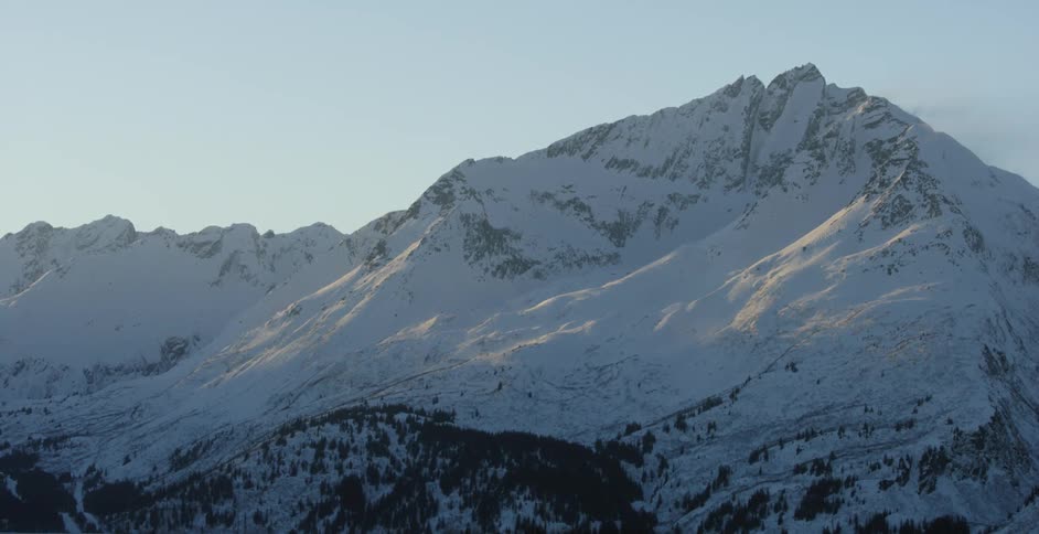 The mountain is white and covered with snow