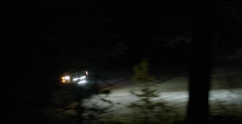 The car travels uphill at night