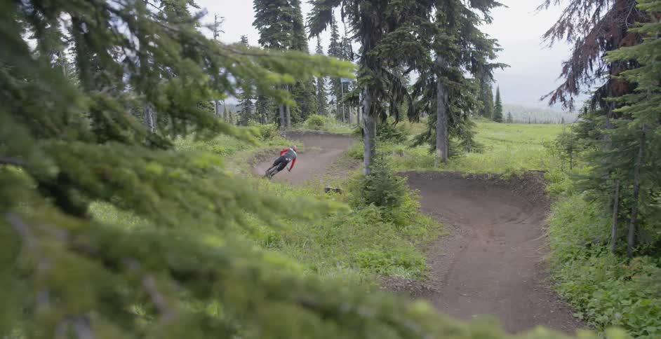 A person rides a course on a mountain bike