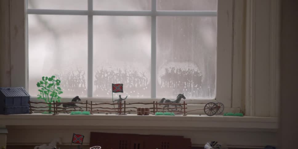 Large windows inside a child's playroom with scene sitting on windowsill