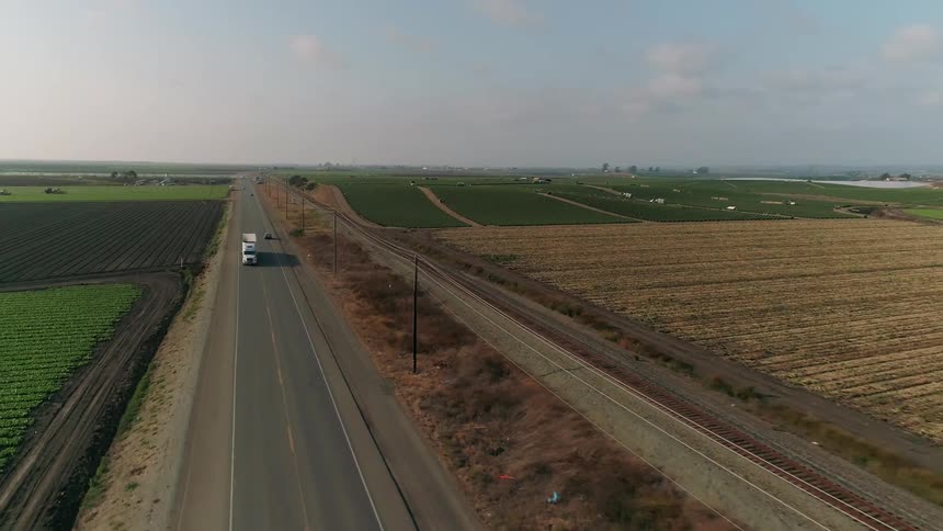 Trucks travel along the long road
