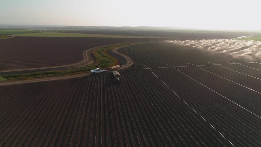 A truck is parked in a rural field