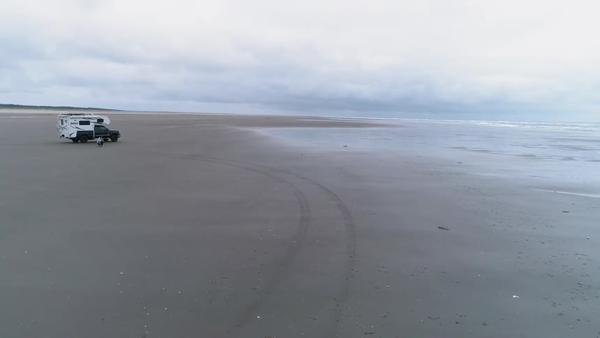 A recreational vehicle is parked on the beach