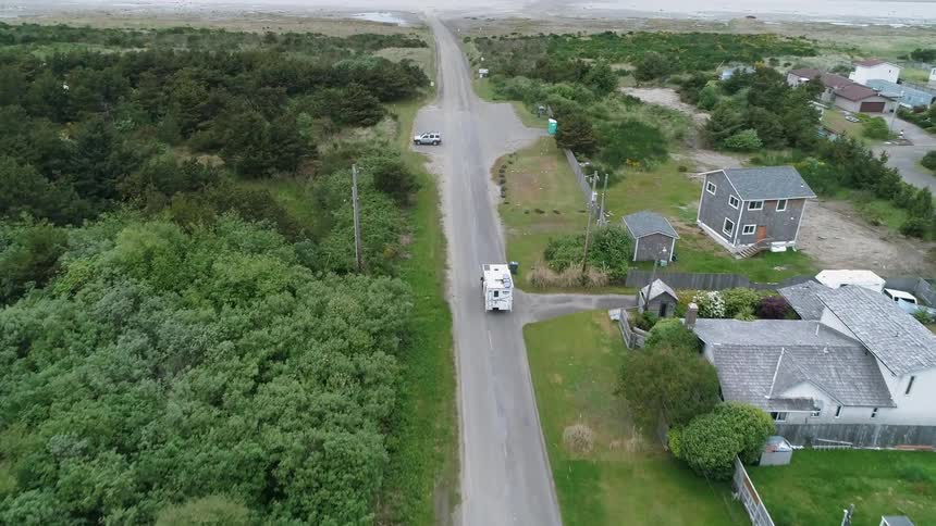 A camper drives on a rural road