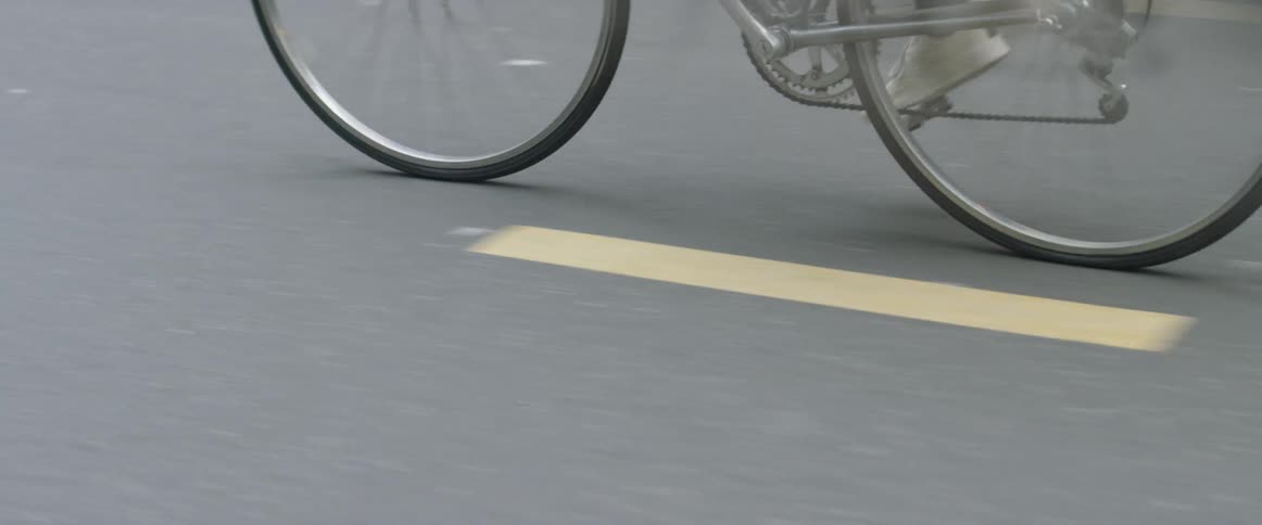 A bicyclist rides on a city street