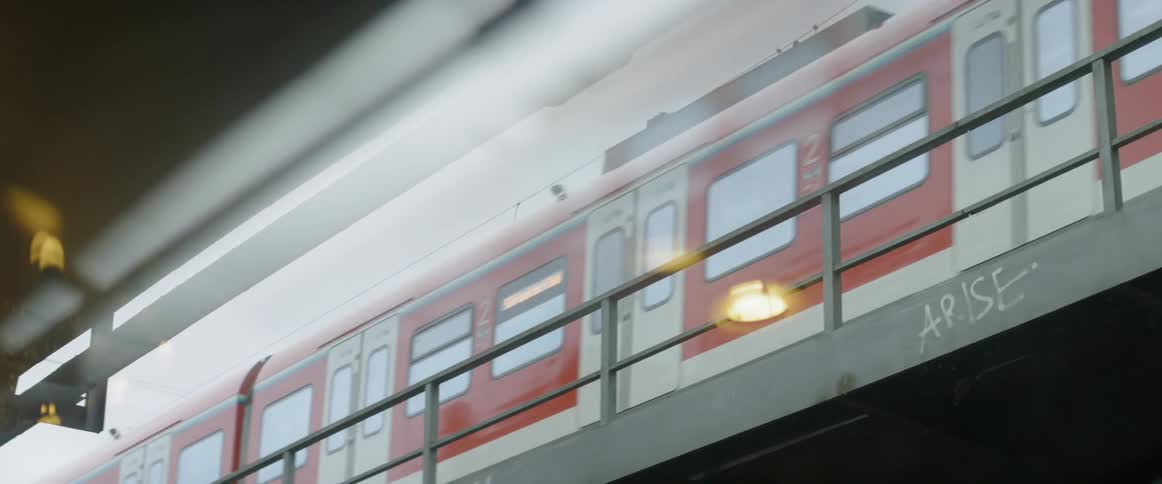 A commuter train is traveling out of a station