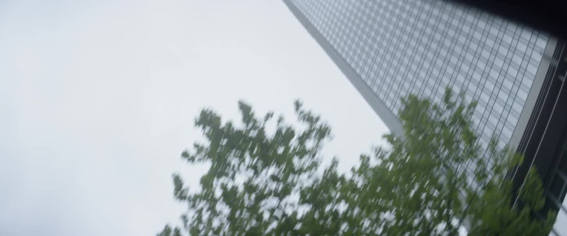 A tall glass skyscraper towers into the sky
