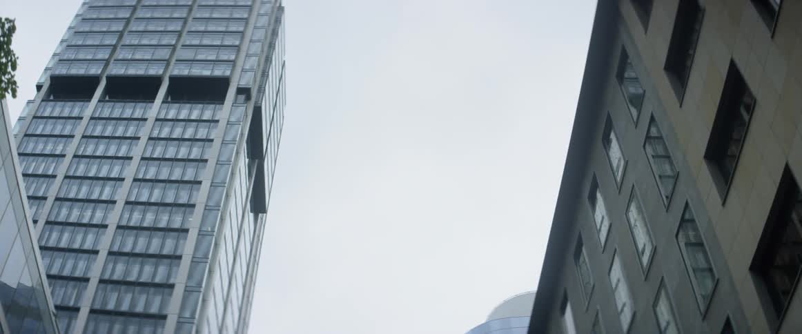 High rises rise above a city street on a cloudy day