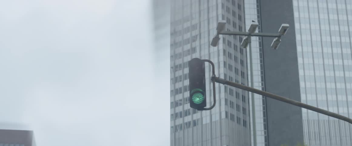 A car drives beneath a traffic light in a city