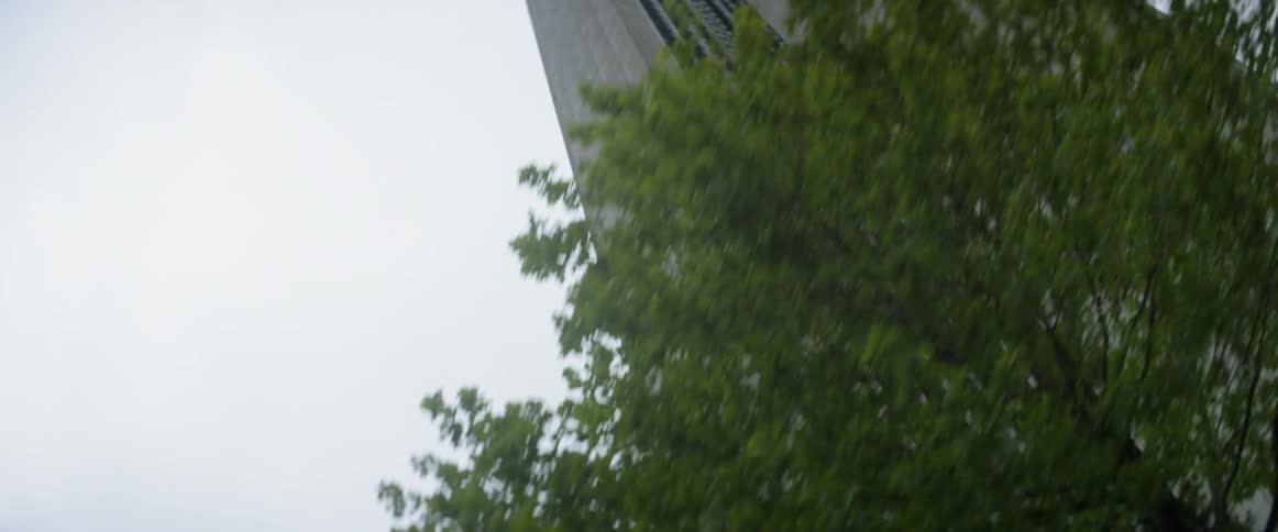 A car drives by city skyscrapers