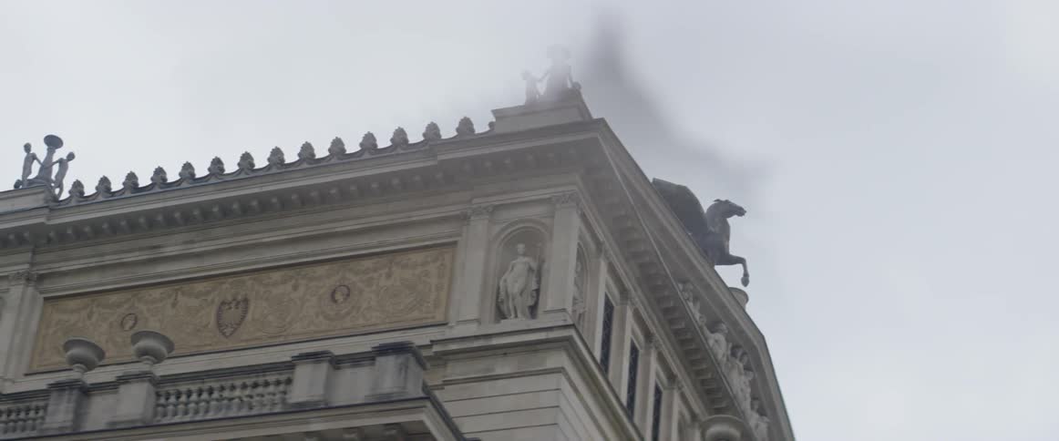 A car drives by a city building