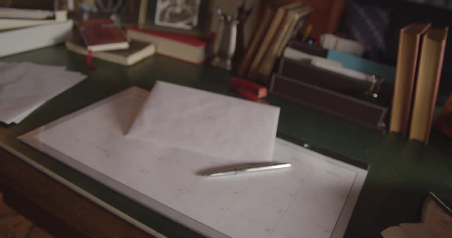 An envelope sitting on top of a desk in a study