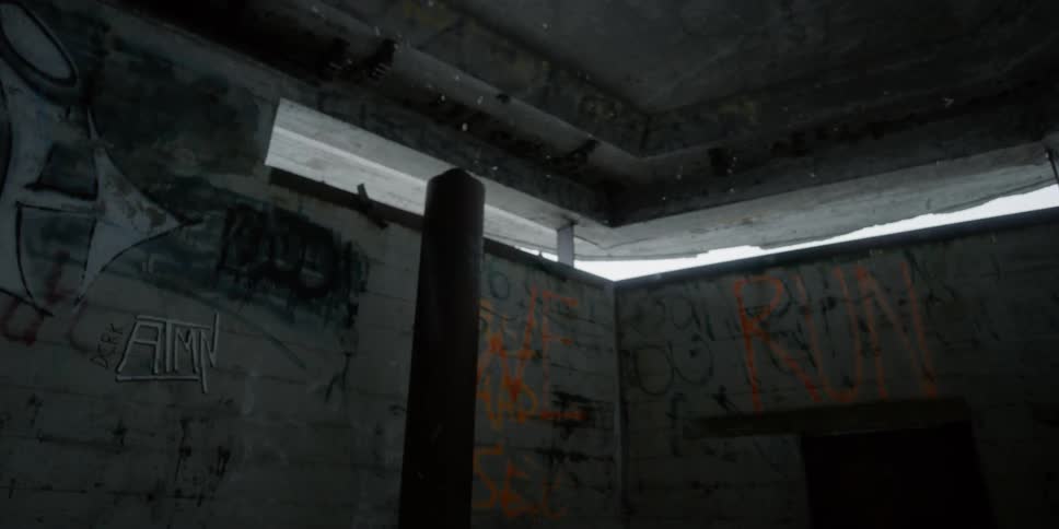 Snow filters through lookout windows in a concrete tower