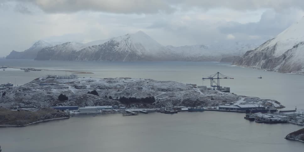 Buildings and a crane along the coast on a winter day